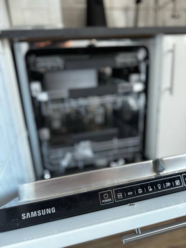 Geöffnete Einbauspülmaschine der Marke Samsung in der Küche einer Monteurwohnung in Frankfurt am Main